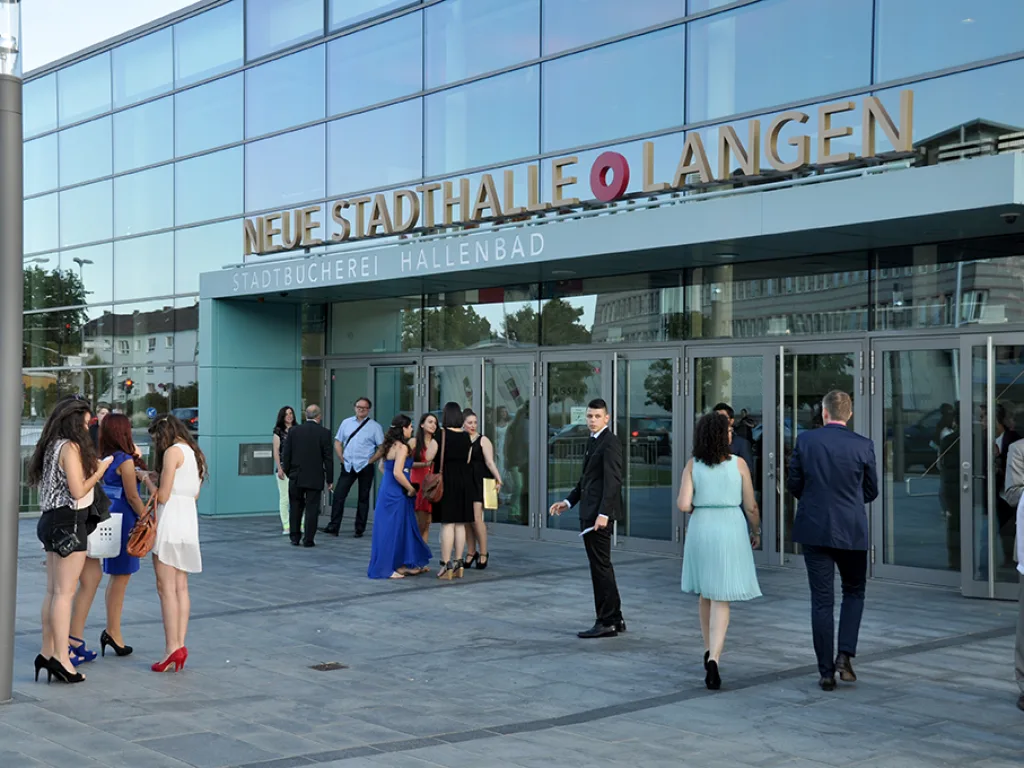 Festlich gekleidete Gäste vor dem Eingang der Stadthalle.